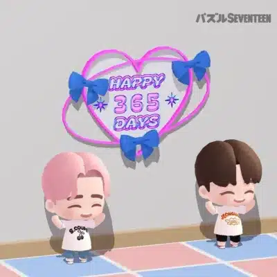SEVENTEENのS.COUPSとJEONGHANのチビキャラが描かれた画像です。ピンクのハートと青いリボンで飾られた「HAPPY 365 DAYS」の文字があり、ゲーム「パズルSEVENTEEN」の365日記念を祝っているようです。
