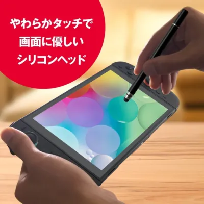 Nintendo Switchのような携帯ゲーム機をスタイラスペンで操作している様子。画面に優しいやわらかタッチのシリコンヘッドが特徴のスタイラスペンが使われていることを示しています。