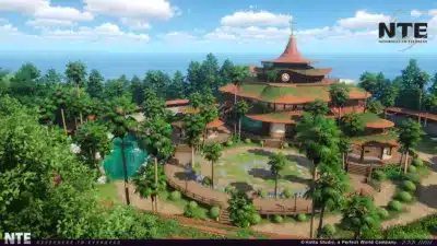 青い空と海を背景に、ヤシの木が生い茂る熱帯の風景の中に建つ、多層構造のユニークな建物。